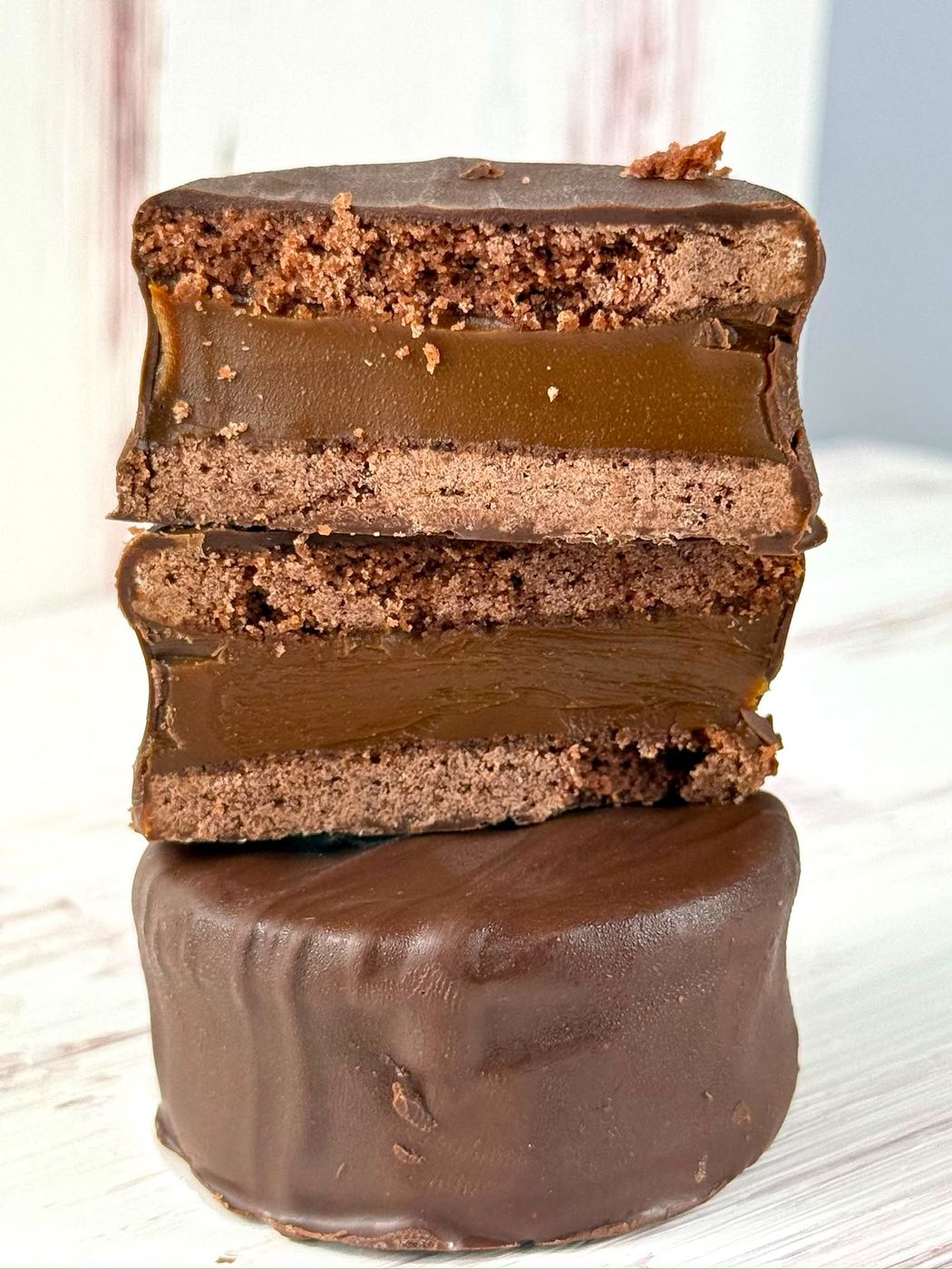 Alfajor negro cortado: galleta de cacao, dulce de leche y chocolate con leche